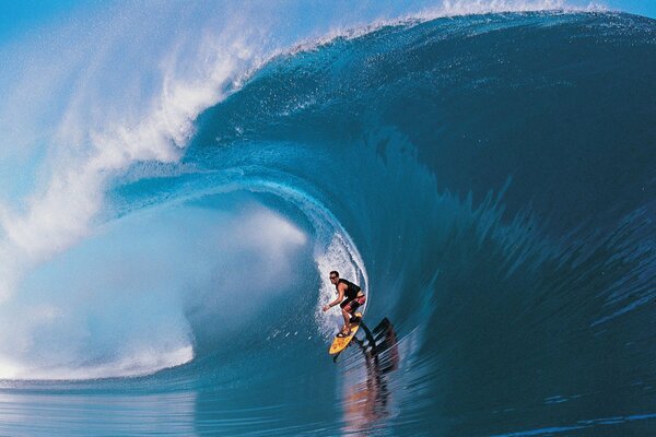 Surfer in the blue ocean wave