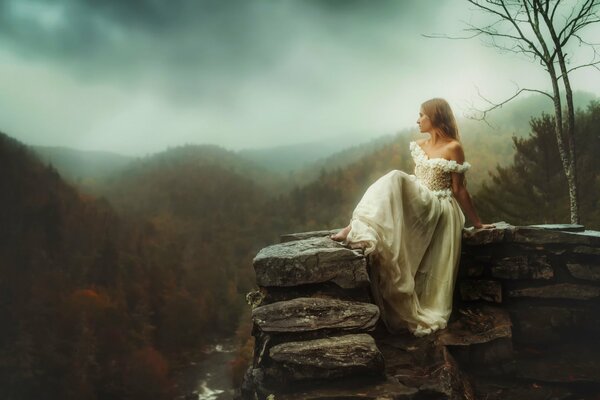 Girl in white on high rocks