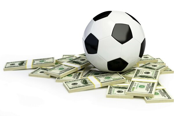 El balón de fútbol yace en fajos de dinero