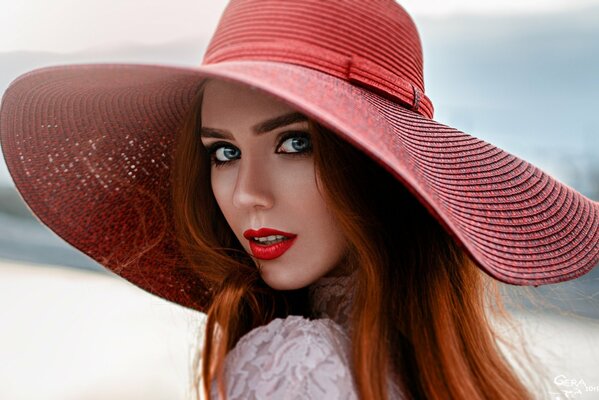 A bright girl in a wide-brimmed hat