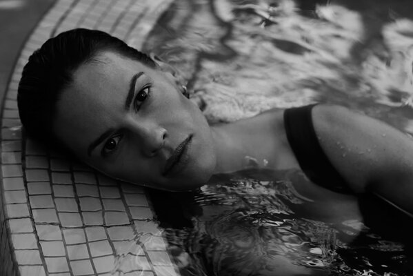 Hilary Swank in the pool looks at the camera