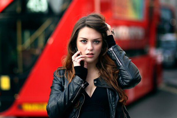 A brown-haired girl in a black jacket