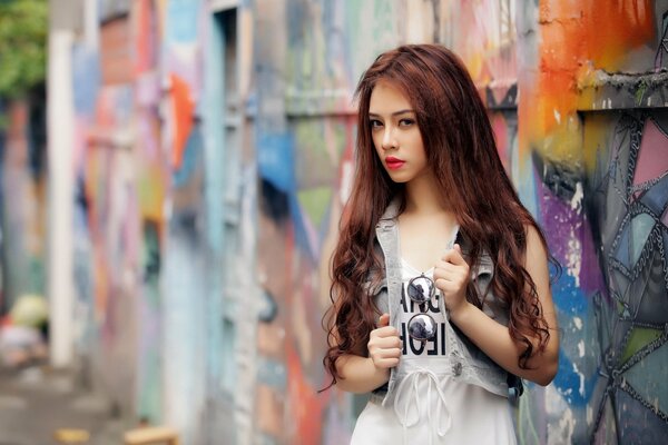 Fille aux cheveux longs au mur avec des graffitis