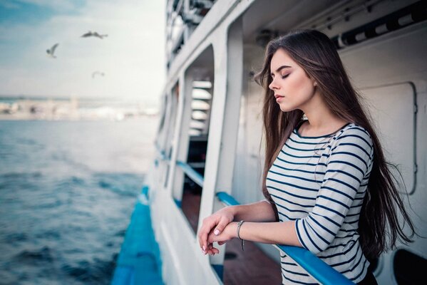 Long-haired girl in a striped blouse