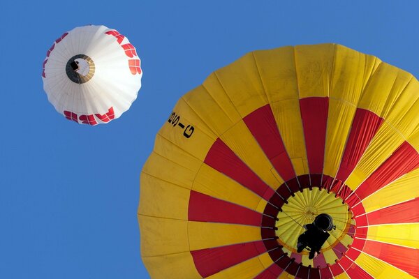 Balls soar in the blue of the sky