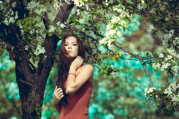 Girl in soda under a flowering tree