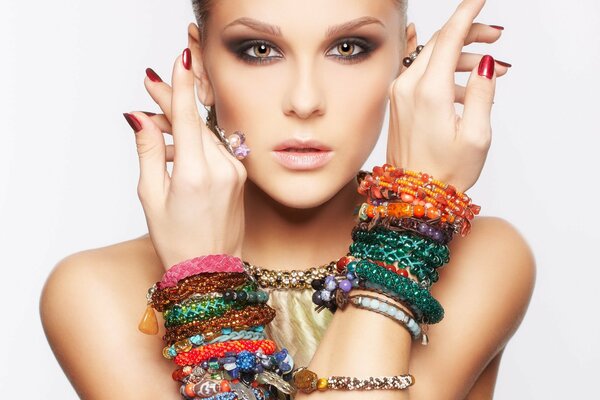 A girl who has a lot of bracelets on her hands