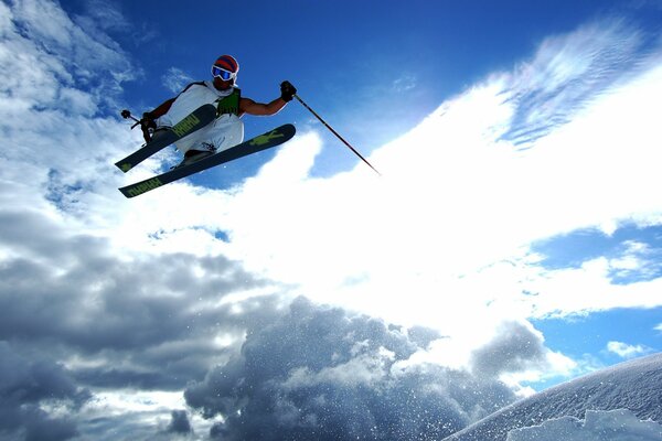 Skier s jump on the background of clouds