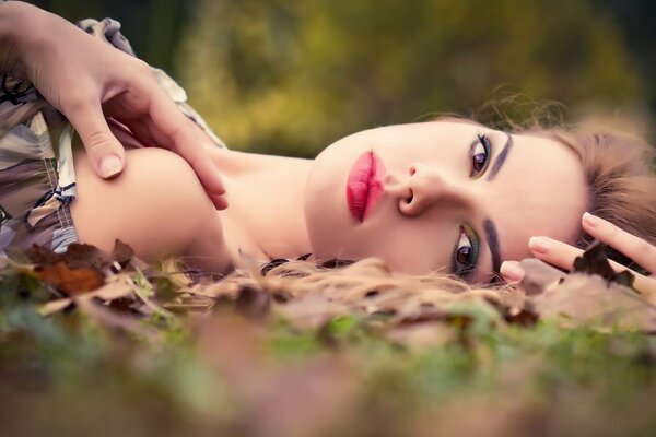 A girl with makeup in nature in autumn