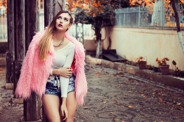 Model girl in pink fur coat