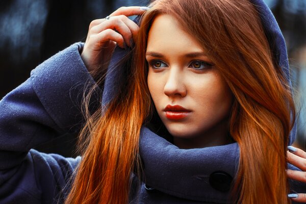 Beautiful red-haired girl in a hood