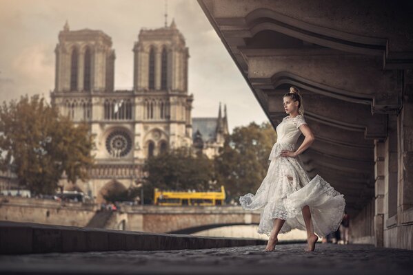 Photo of a girl dancing under a bridge