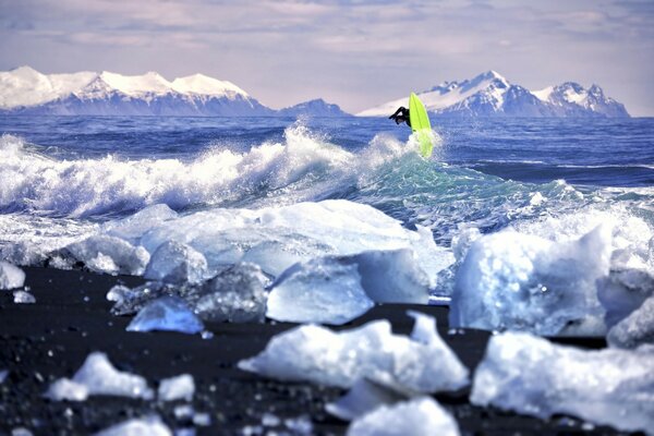 A wave of surf beating against the icy shore