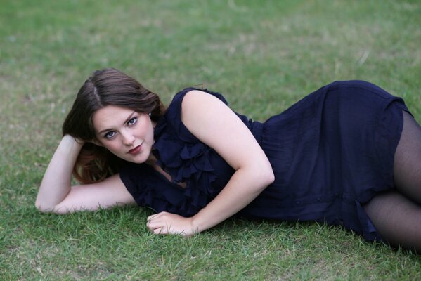 Girl posing lying on the grass