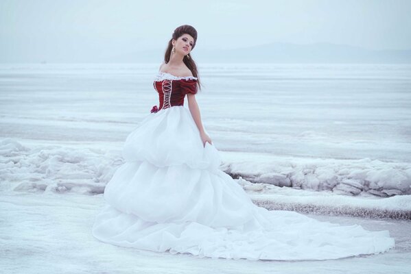 Photo of a brown-haired woman in winter on the ice lake