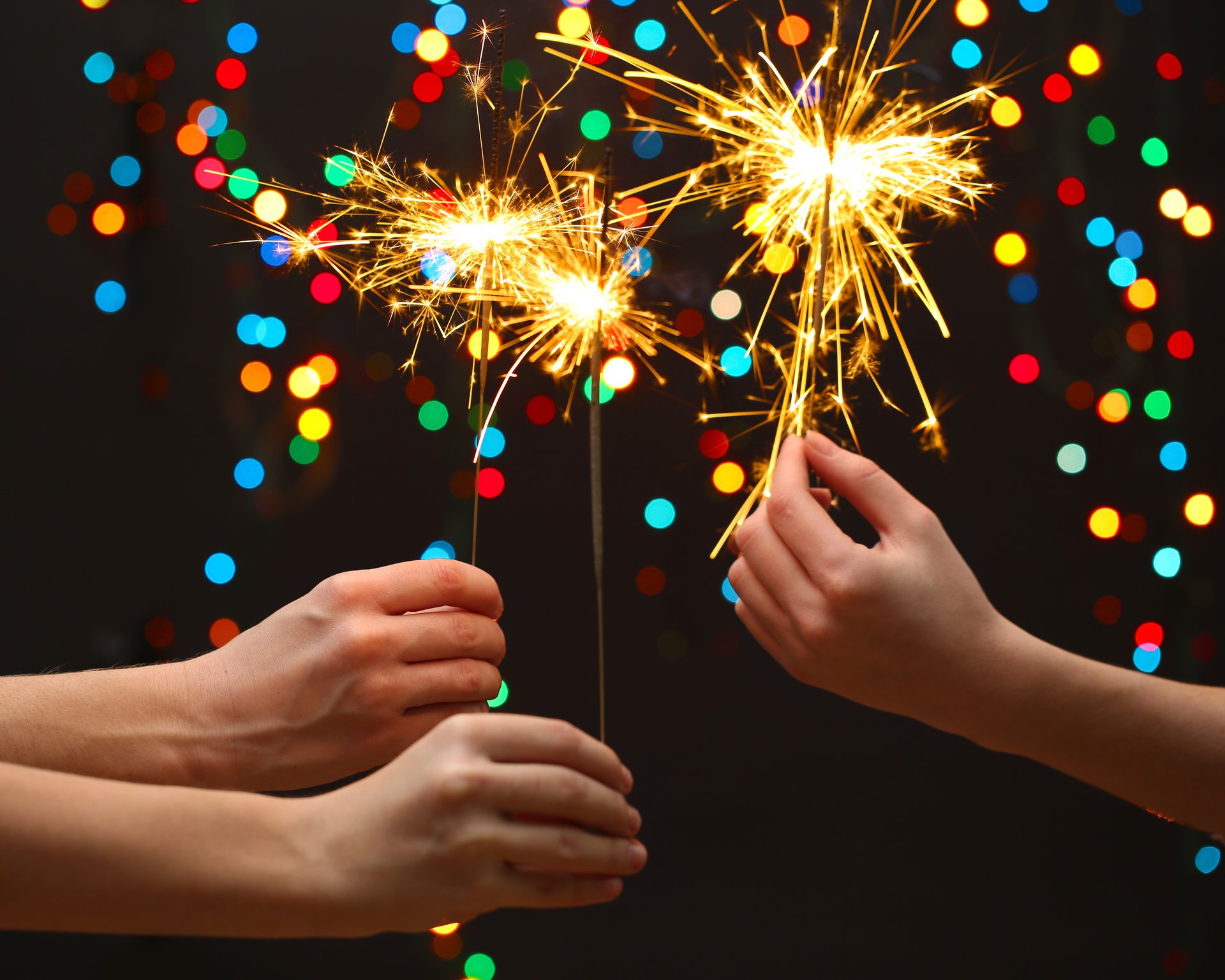 to celebrate merry christmas little girls sparklers new year light children hands bokeh