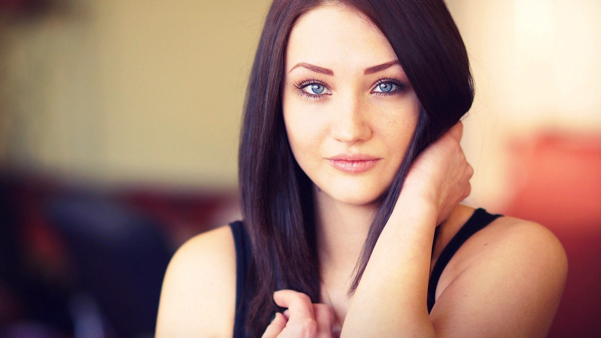 girl blue eyes brunette hair face blurred background beautiful