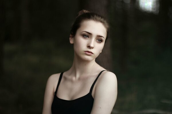 A girl in a black top in nature