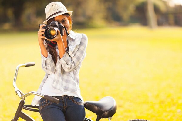 A girl cyclist with a camera