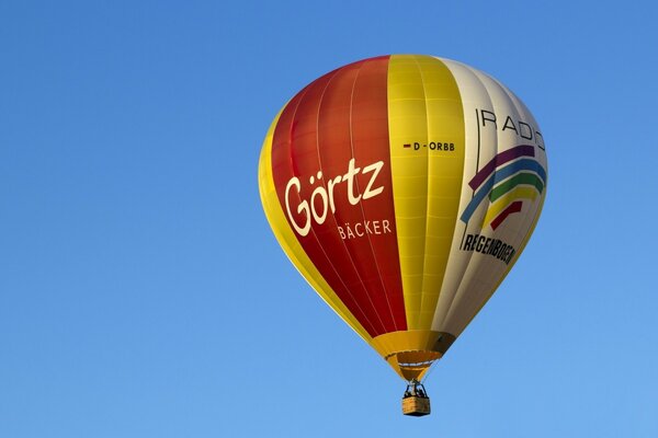 Fozdushny multicolored ball flies across the blue sky