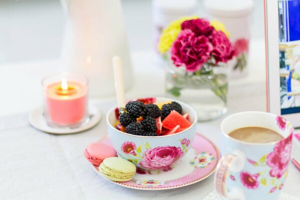 A plate of fruits and berries with cookies