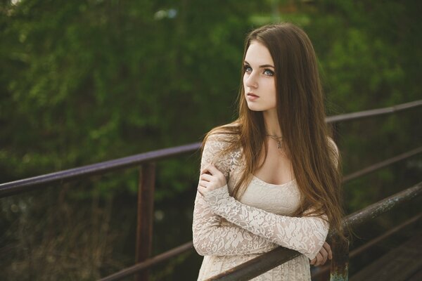 Girl on the bridge in a lace dress