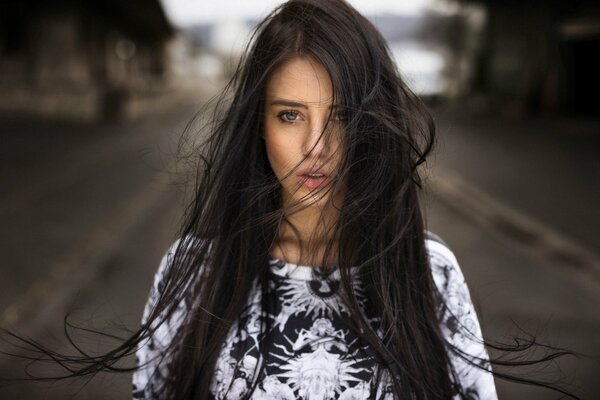 Brünette Mädchen mit sich entwickelnden Haaren im Wind