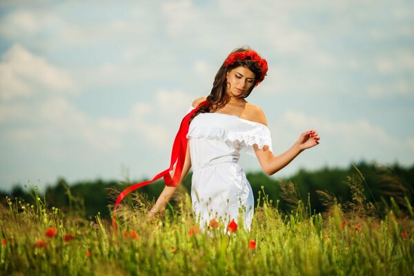 A girl walks through a poppy field