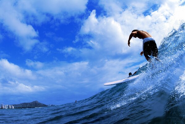 A man is surfing in the ocean