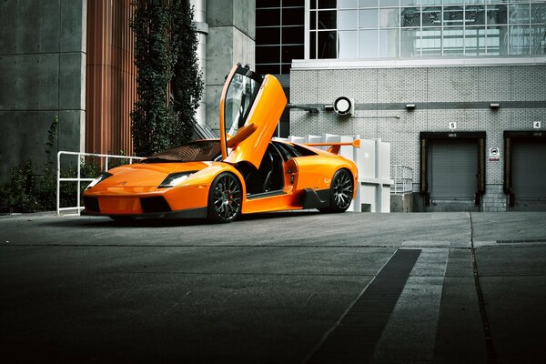 An orange Lamborghini is on the road
