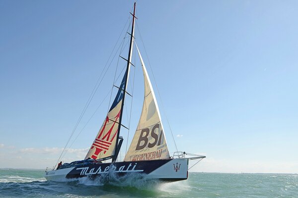 Photo of a sailboat floating on the waves