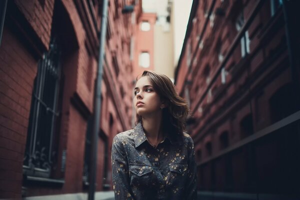 A girl among tall houses