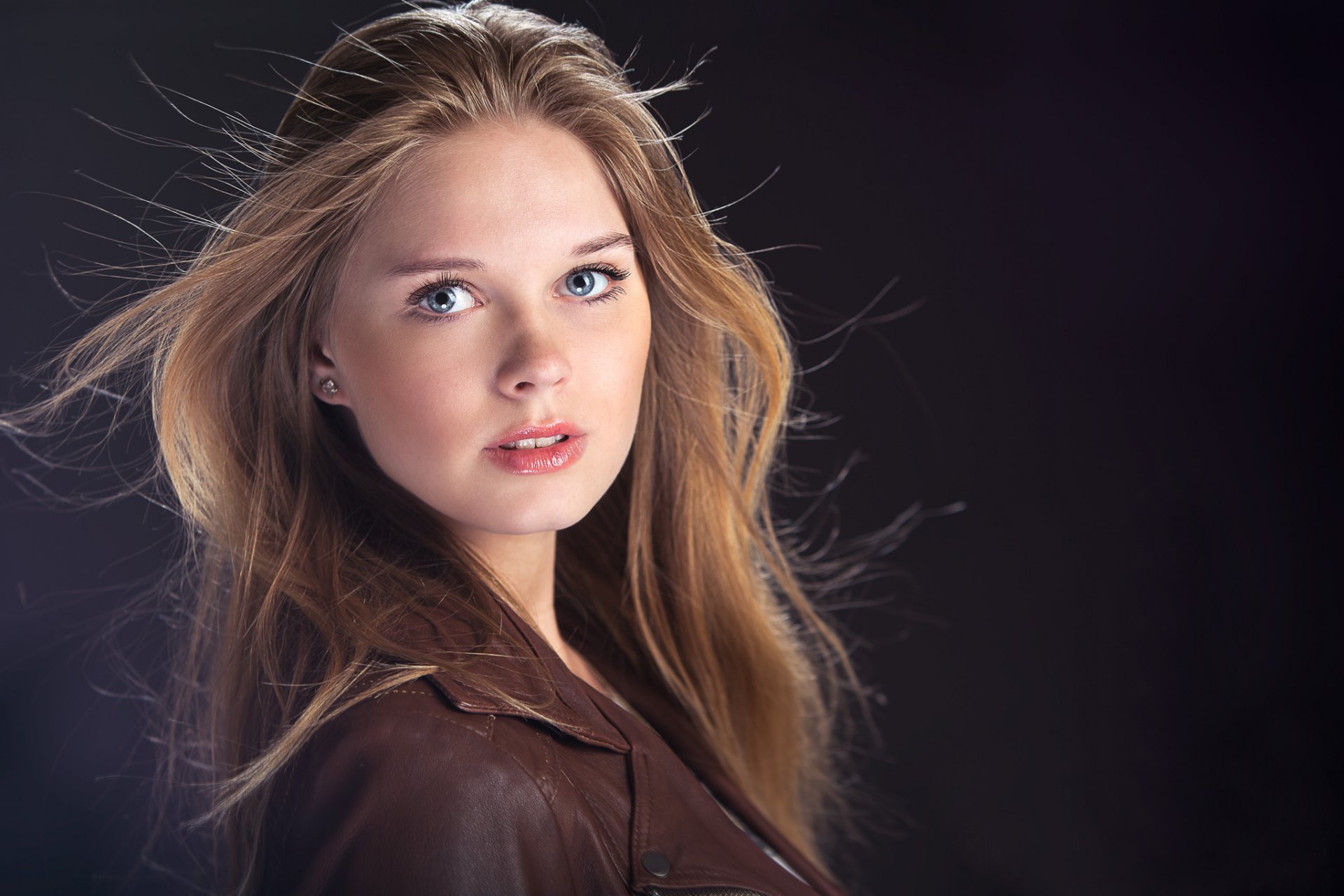 girl blonde blue eyes dark background portrait