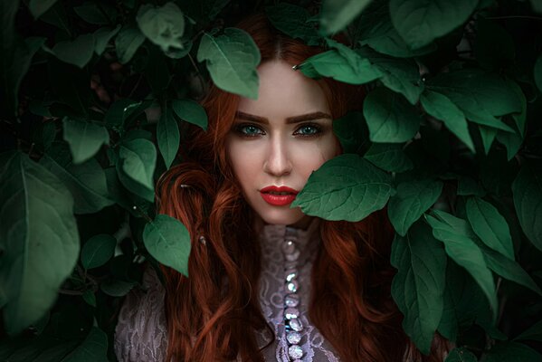 Red-haired girl in leaves