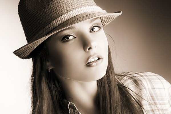 A girl in a hat and shirt at a photo shoot