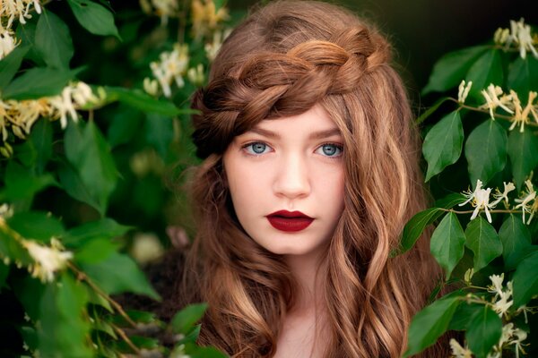 Portrait of a flower fairy in the bushes