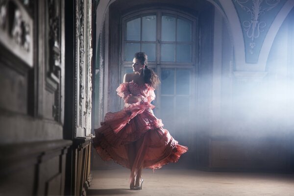 In a lush red dress, a thoughtful girl