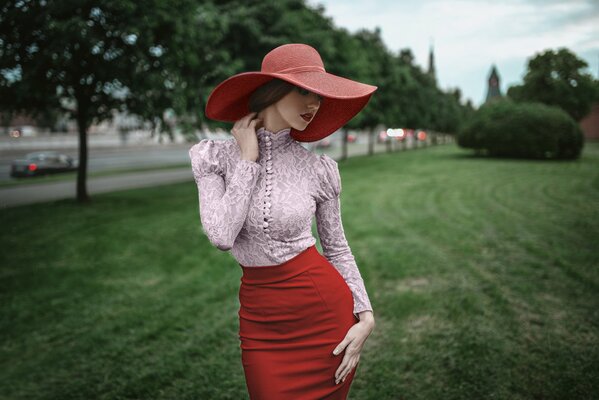 A girl in a red dress and a red hat