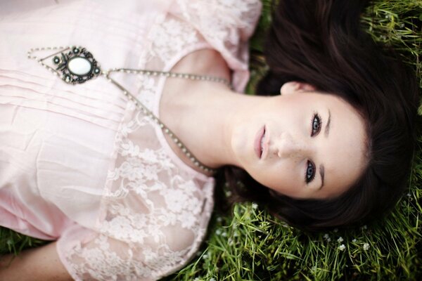 Brunette with an unusual pendant at a photo shoot