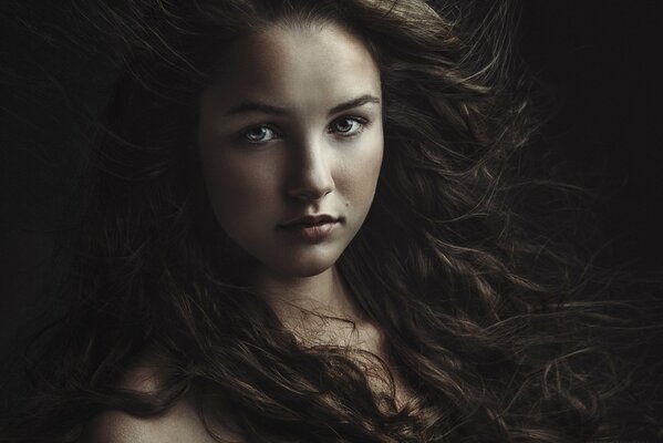 Portrait of a girl with long developing hair