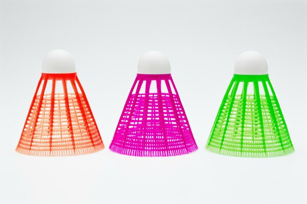 Colored badminton shuttlecocks on a white background