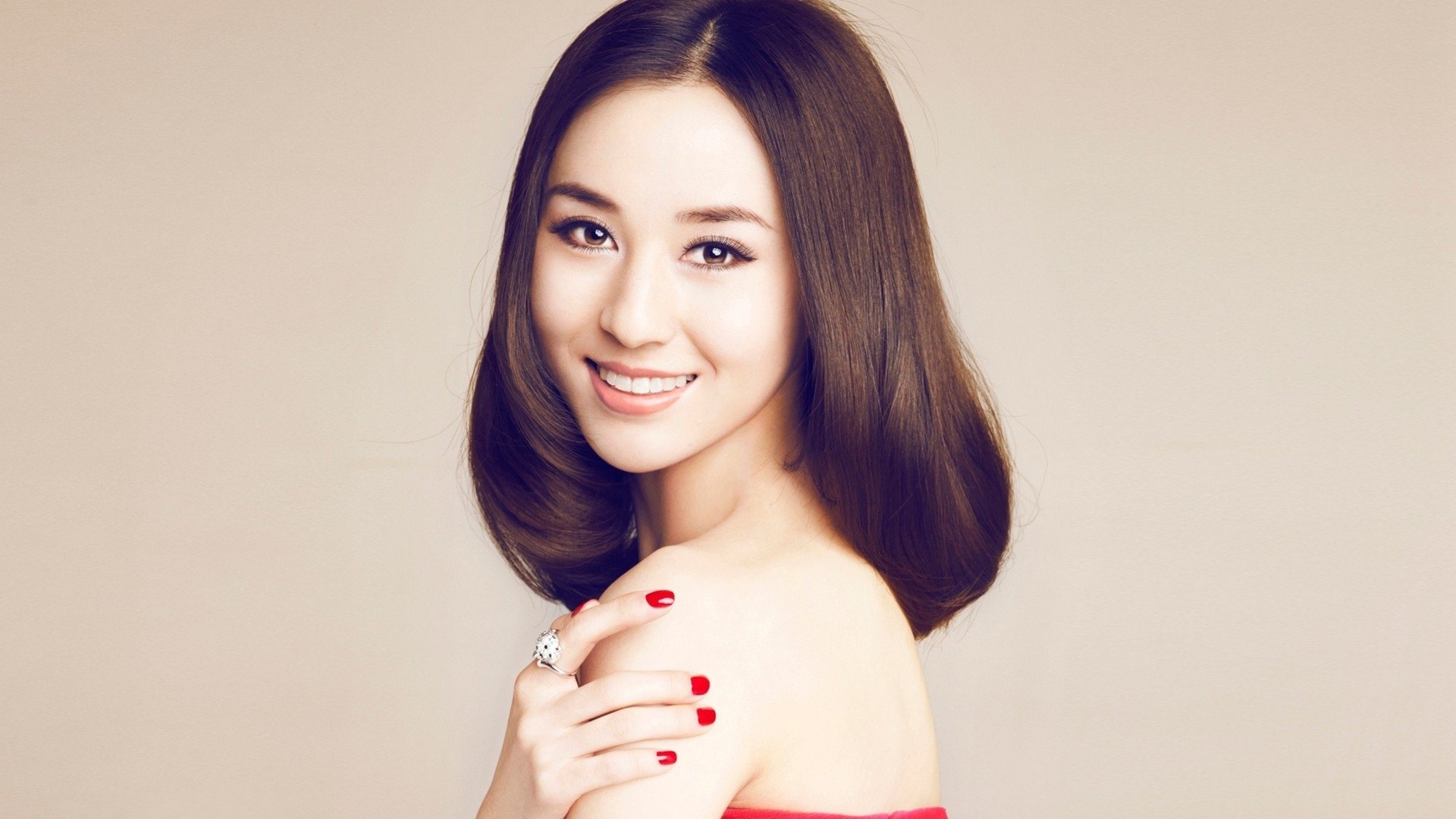 girl face asian smile hair make-up hand manicure red nails ring background