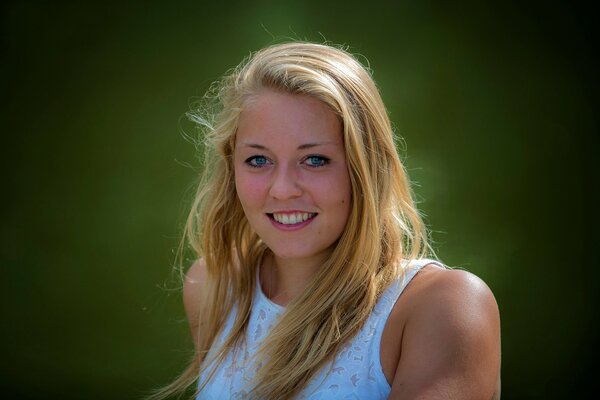 Blonde girl with blue eyes smiles