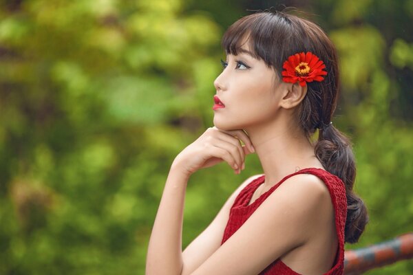 Fille asiatique avec une fleur dans les cheveux