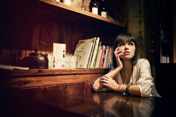 Pensive brunette at the mysterious closet