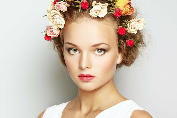 Portrait of a girl with flowers in her hairstyle