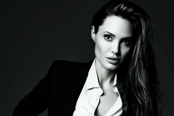 Black and white photo of Angelina Jolie in a black suit and white shirt