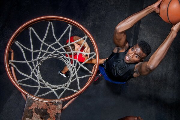 Joueur jette la balle dans le panier de basket-ball