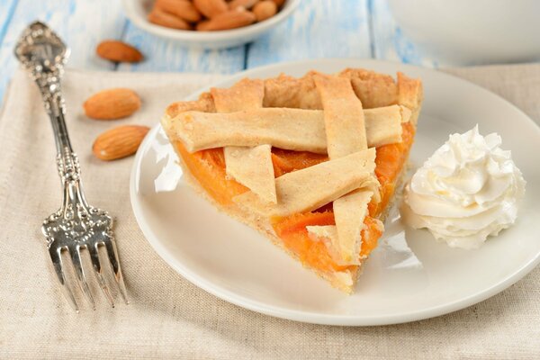 A piece of pie with apricot filling and almonds