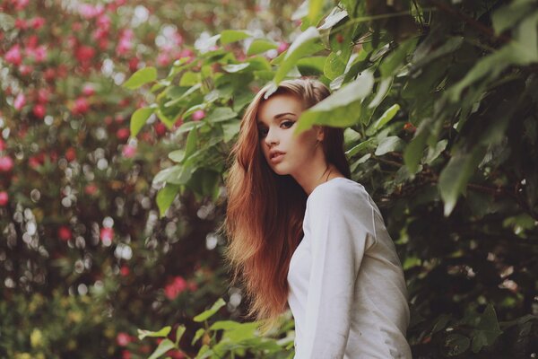 Girl with long hair in the garden